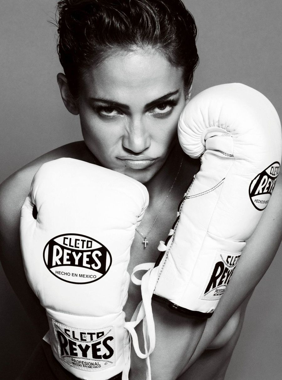 Boxer resting white gloves on her shoulders, black and white portrait
