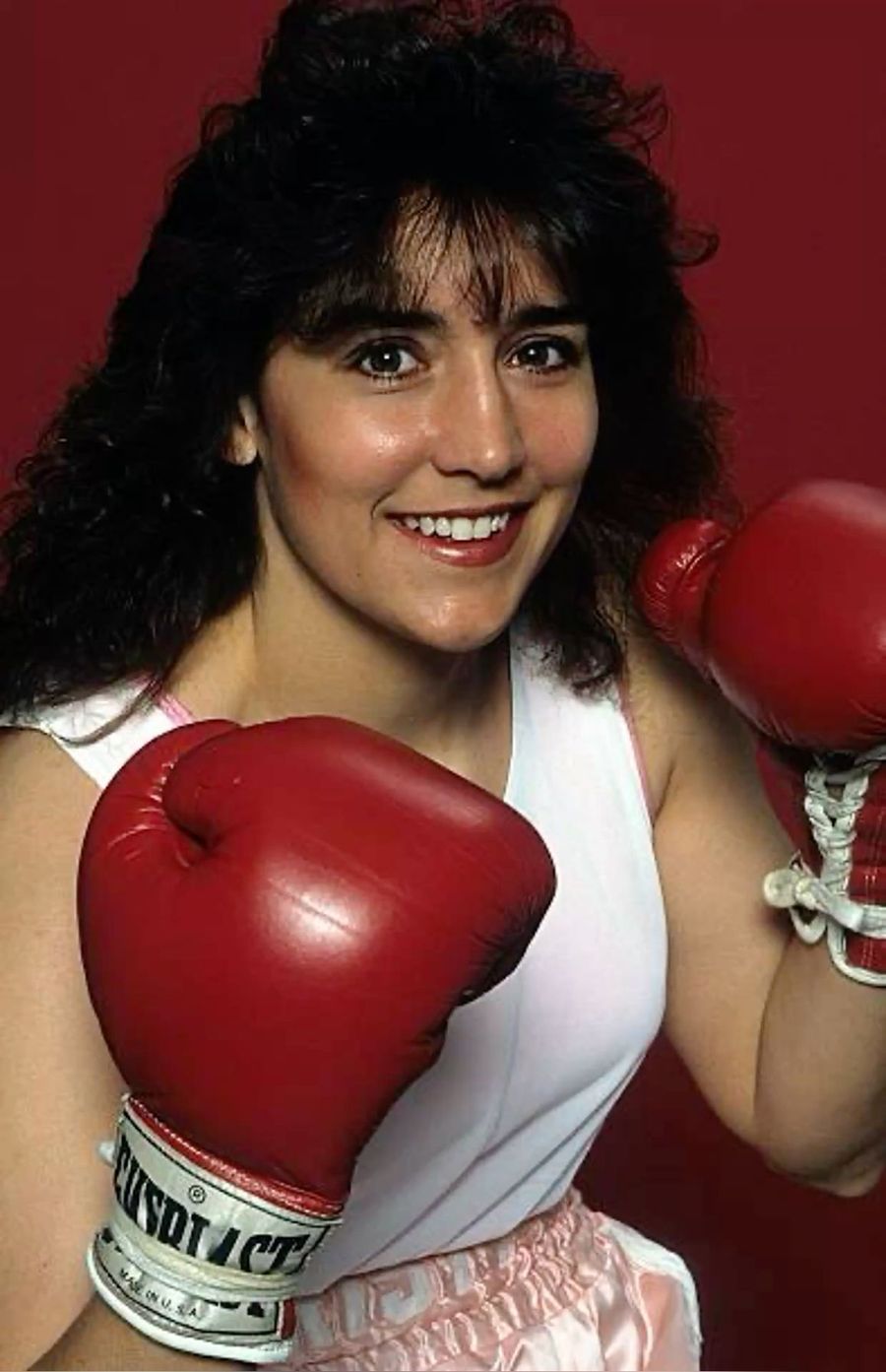 Boxer in red gloves smiling after a win, 1980s