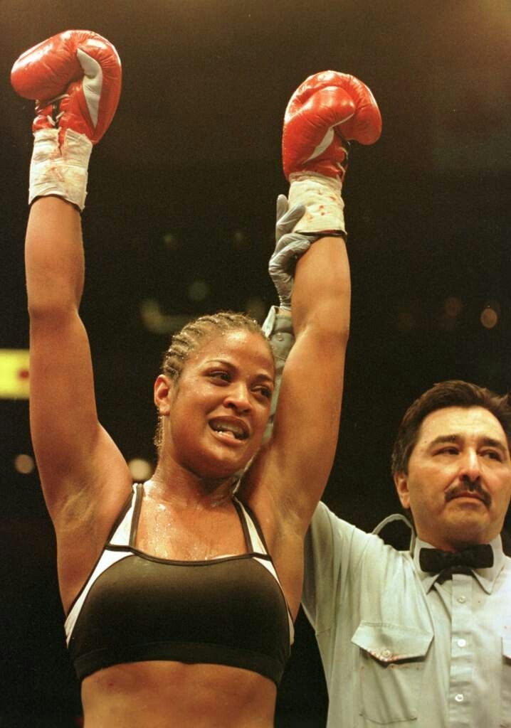 Champion with her arm raised by the referee