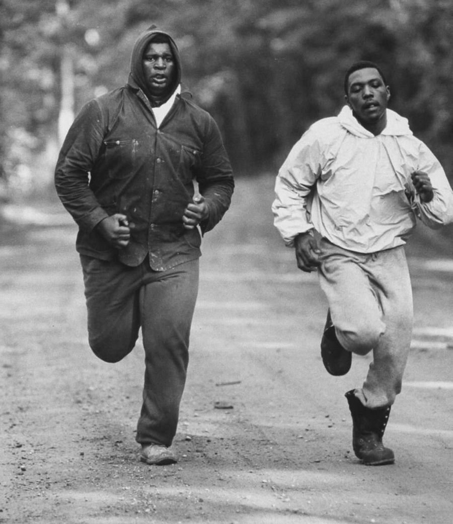 Two boxers on an early-morning training run, black and white